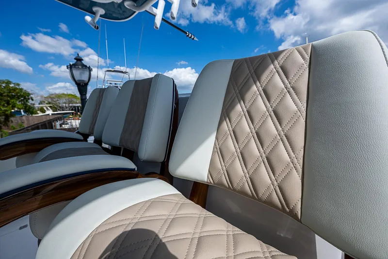  Yacht Photos Pics Luxurious seating on 2025 Invincible 38 Catamaran with quilted upholstery under blue sky.