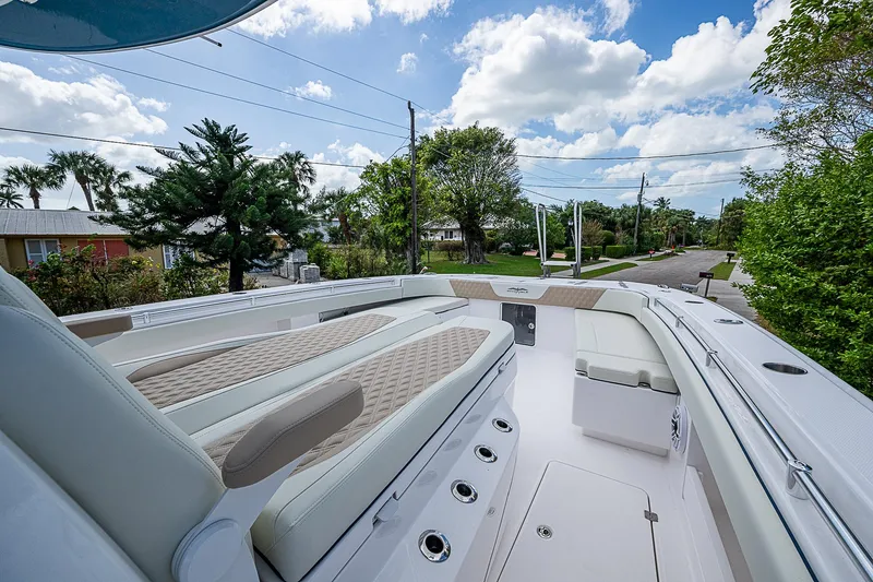  Yacht Photos Pics 2025 Invincible 38 Catamaran with luxurious seating and sleek design on a sunny day.