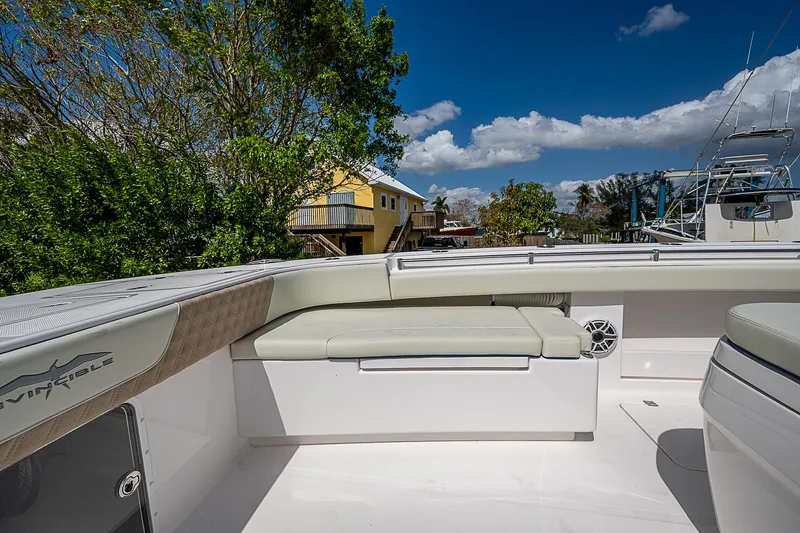  Yacht Photos Pics 2025 Invincible 38 Catamaran deck with cushioned seating under a clear blue sky.