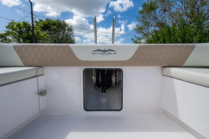  Yacht Photos Pics 2025 Invincible 38 Catamaran deck view with storage compartment and seating.