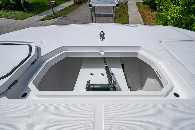  Yacht Photos Pics 2025 Invincible 38 Catamaran anchor storage compartment, open and empty, on a sunny day.