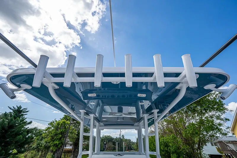  Yacht Photos Pics 2025 Invincible 38 Catamaran with rod holders, viewed from below against a blue sky.