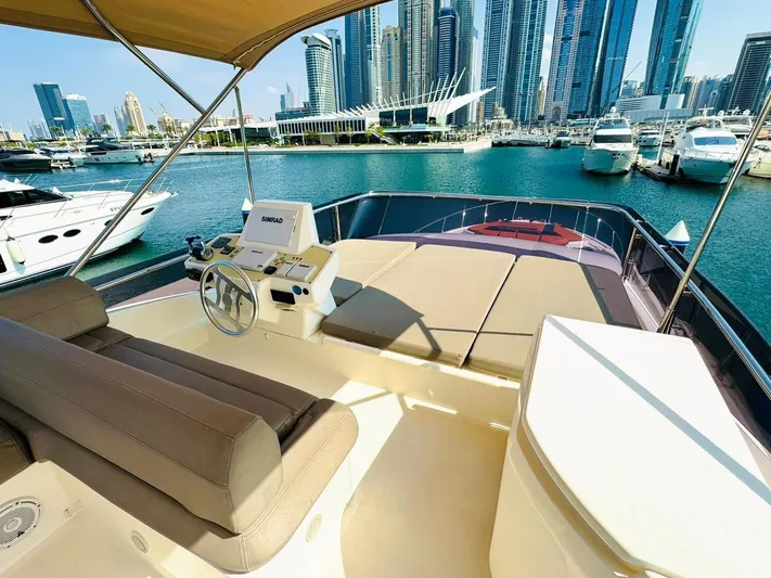  Yacht Photos Pics Flybridge view of 2015 Ferretti Yachts 550 in a marina with city skyline.