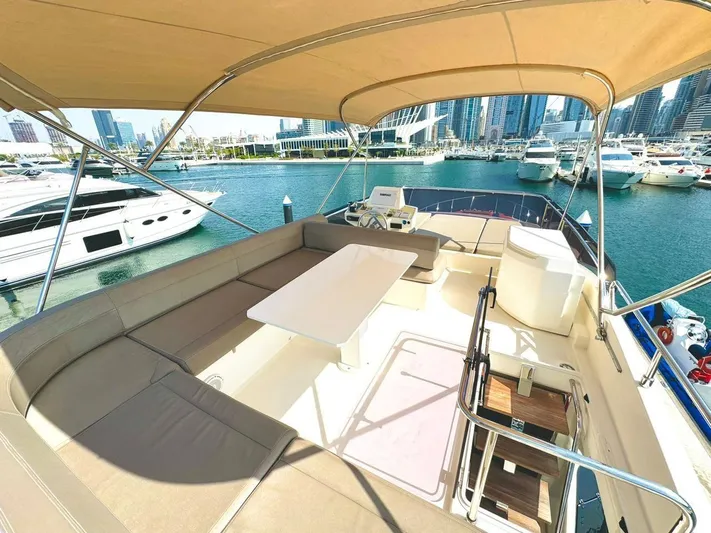  Yacht Photos Pics Flybridge of 2015 Ferretti Yachts 550 with seating and table, docked in a marina.