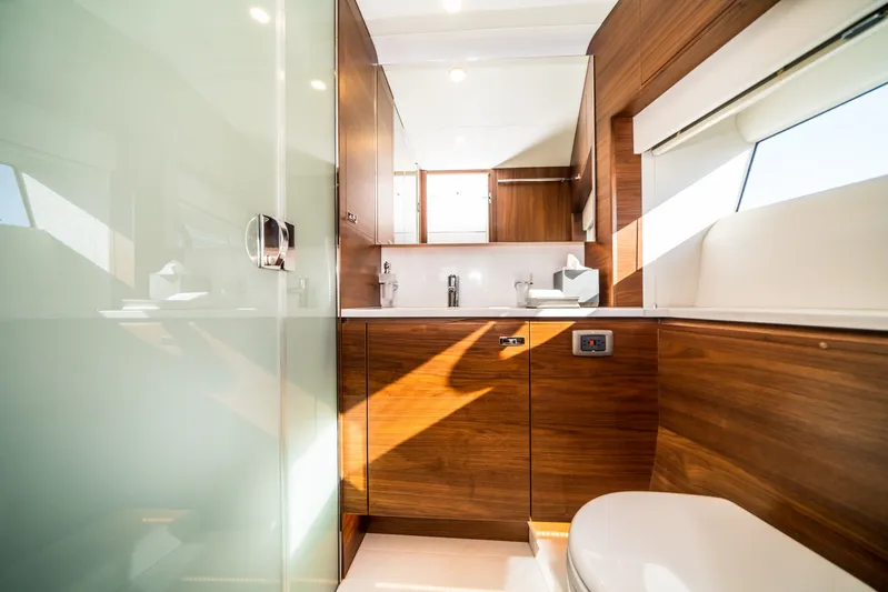 Record Year Yacht Photos Pics Luxurious bathroom interior on 2021 Princess Y85 Motor Yacht with wood finish and modern fixtures.