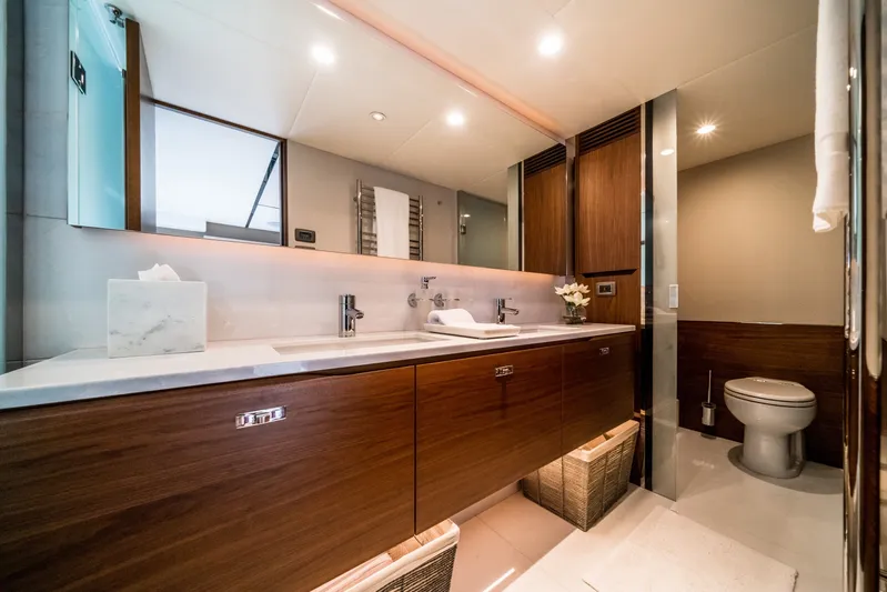 Record Year Yacht Photos Pics Luxurious bathroom on 2021 Princess Y85 Motor Yacht with modern fixtures and elegant wood cabinetry.