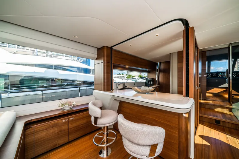 Record Year Yacht Photos Pics Luxurious interior of 2021 Princess Y85 Motor Yacht with modern wood finishes and seating.
