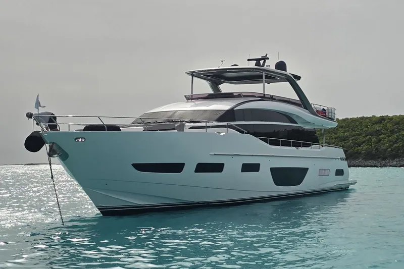 Record Year Yacht Photos Pics 2021 Princess Y85 Motor Yacht on turquoise water, sleek design, anchored near lush island.