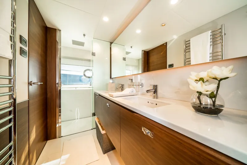 Record Year Yacht Photos Pics Luxurious bathroom on 2021 Princess Y85 Motor Yacht with elegant wood finishes and modern fixtures.