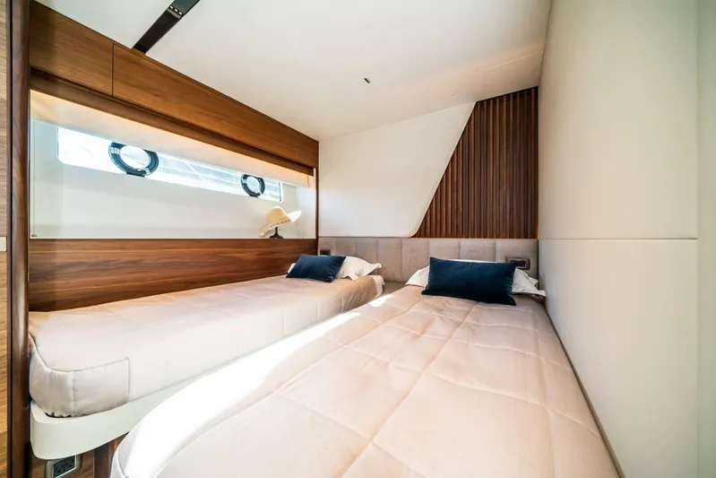 Record Year Yacht Photos Pics Luxurious twin bedroom on 2021 Princess Y85 Motor Yacht with modern wood accents.