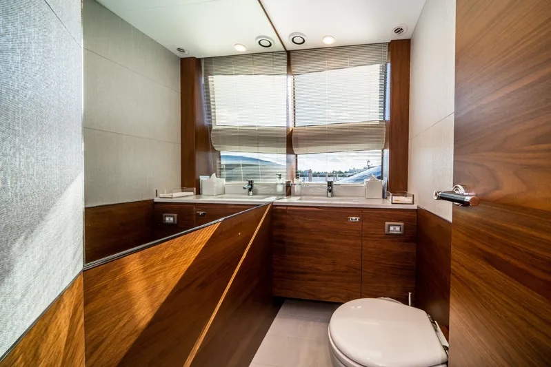Record Year Yacht Photos Pics Luxurious bathroom interior on 2021 Princess Y85 Motor Yacht with wood accents and modern fixtures.