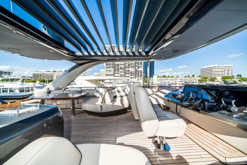 Record Year Yacht Photos Pics Luxurious 2021 Princess Y85 Motor Yacht interior with modern seating and helm, docked in a marina.