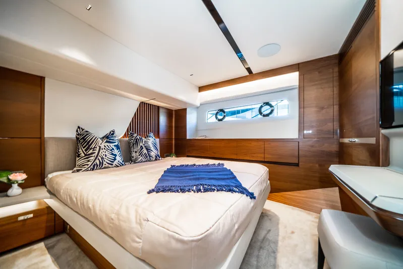 Record Year Yacht Photos Pics Luxurious bedroom interior of 2021 Princess Y85 Motor Yacht with elegant wood finishes.