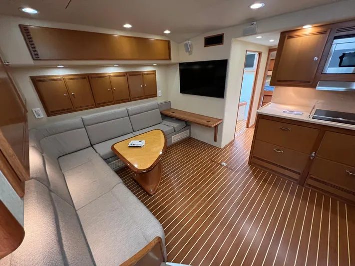 Pacific Adventures Yacht Photos Pics Luxurious 2008 Cabo 52 Express yacht interior with sleek wood flooring and modern furnishings.