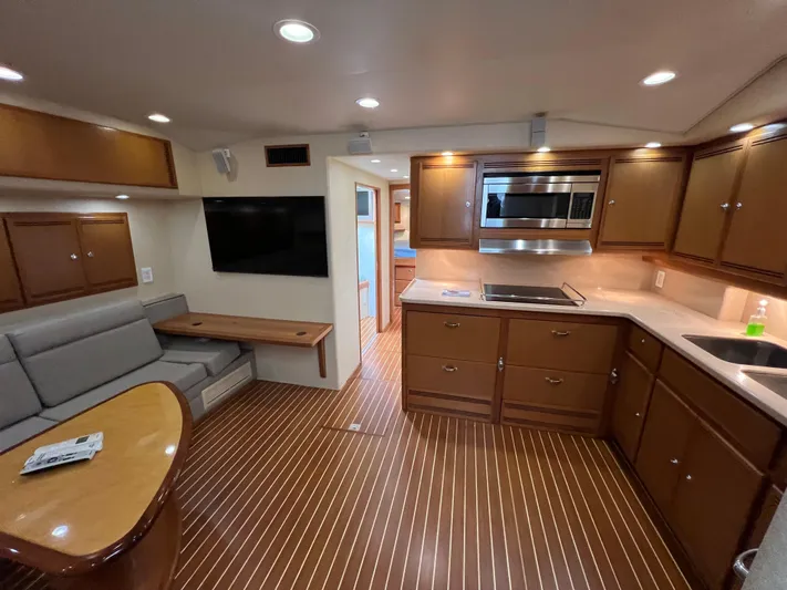 Pacific Adventures Yacht Photos Pics Luxurious 2008 Cabo 52 Express yacht interior with modern kitchen and cozy seating area.