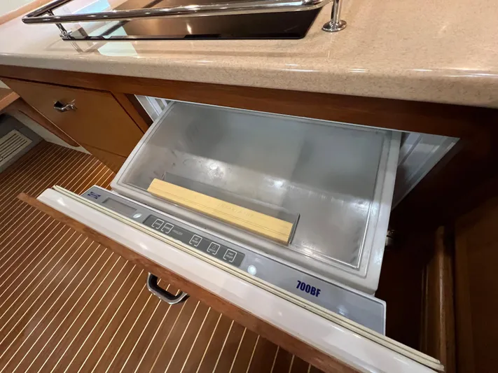 Pacific Adventures Yacht Photos Pics Open drawer refrigerator in 2008 Cabo 52 Express yacht kitchen.