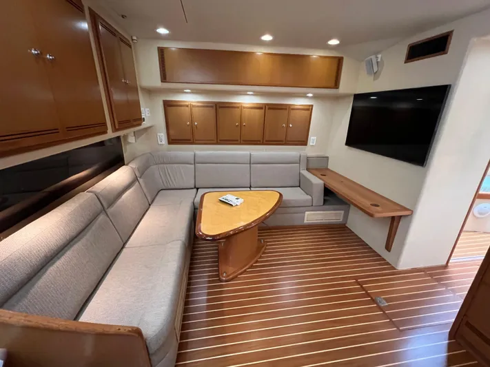 Pacific Adventures Yacht Photos Pics Luxurious interior of 2008 Cabo 52 Express yacht with plush seating and modern amenities.