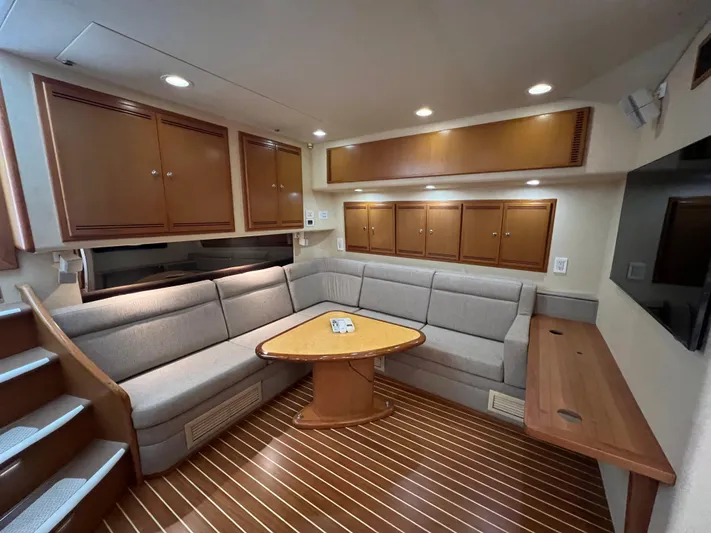 Pacific Adventures Yacht Photos Pics Luxurious 2008 Cabo 52 Express yacht interior with cozy seating and elegant wood finishes.