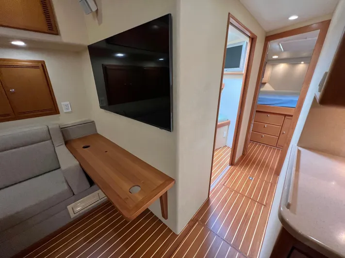 Pacific Adventures Yacht Photos Pics Interior of 2008 Cabo 52 Express yacht with wood flooring and modern furnishings.