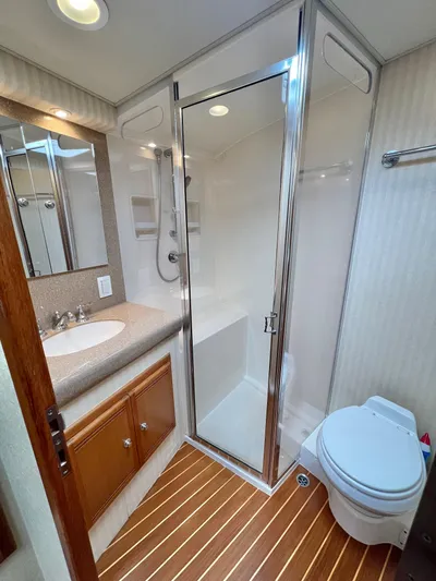 Pacific Adventures Yacht Photos Pics Luxurious 2008 Cabo 52 Express yacht bathroom with shower, sink, and toilet.