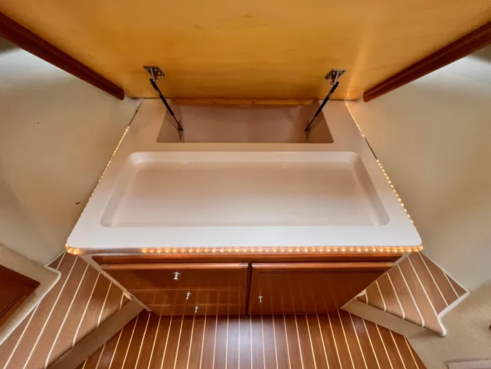 Pacific Adventures Yacht Photos Pics 2008 Cabo 52 Express yacht interior with sleek countertop and wooden cabinetry.