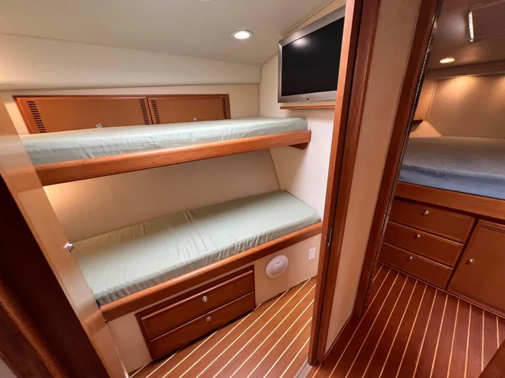 Pacific Adventures Yacht Photos Pics 2008 Cabo 52 Express yacht interior with bunk beds and wood flooring.