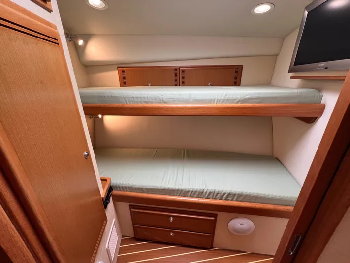 Pacific Adventures Yacht Photos Pics 2008 Cabo 52 Express cabin with bunk beds and TV.