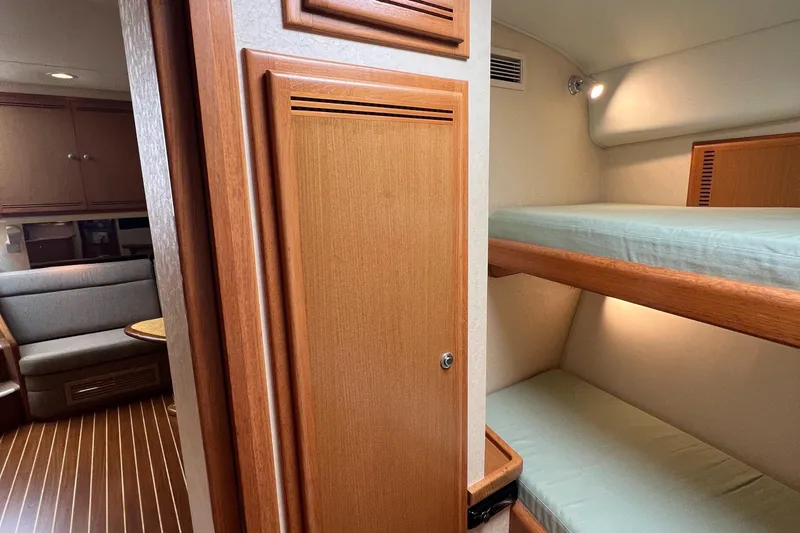 Pacific Adventures Yacht Photos Pics 2008 Cabo 52 Express interior with bunk beds and seating area.