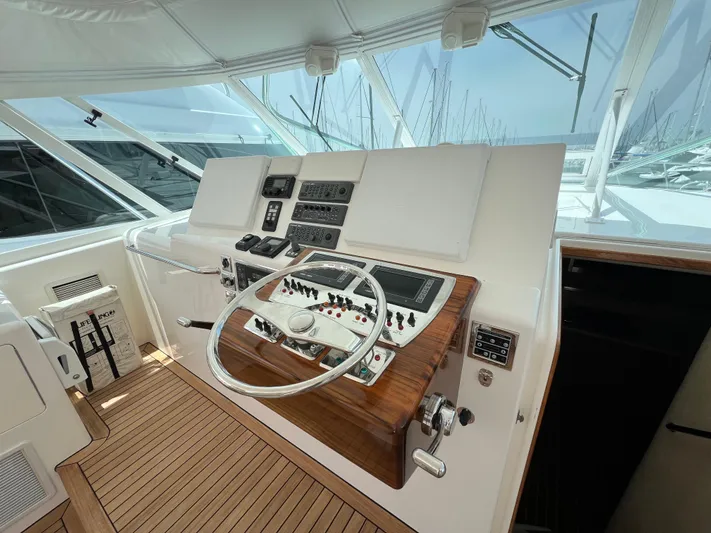 Pacific Adventures Yacht Photos Pics 2008 Cabo 52 Express yacht helm with wooden dashboard and steering wheel.