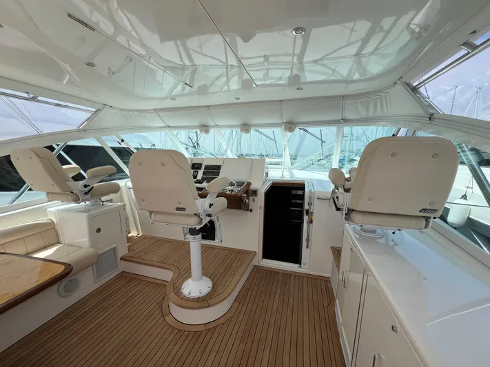 Pacific Adventures Yacht Photos Pics Luxurious 2008 Cabo 52 Express yacht interior with helm and seating area.