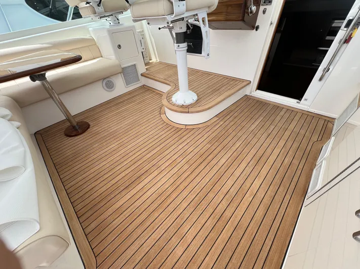 Pacific Adventures Yacht Photos Pics 2008 Cabo 52 Express boat interior with teak flooring and white seating.