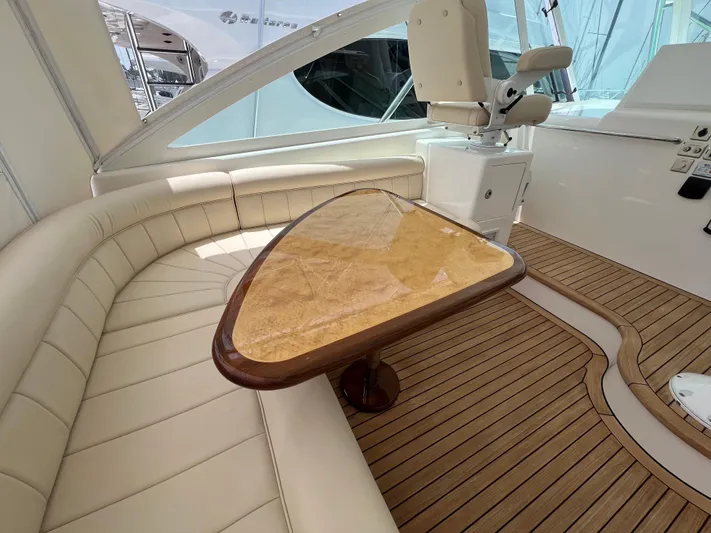 Pacific Adventures Yacht Photos Pics Luxurious interior of 2008 Cabo 52 Express yacht with elegant seating and wooden table.