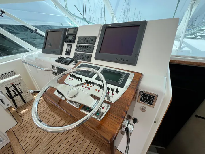 Pacific Adventures Yacht Photos Pics 2008 Cabo 52 Express helm with dual screens and wooden accents.