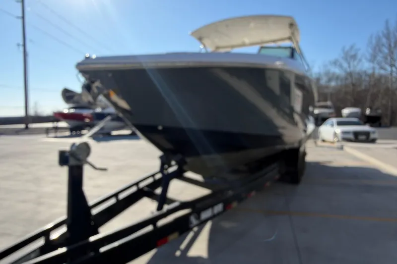  Yacht Photos Pics Blurred image of a 2019 Cobalt R35 boat on a trailer in a parking lot.