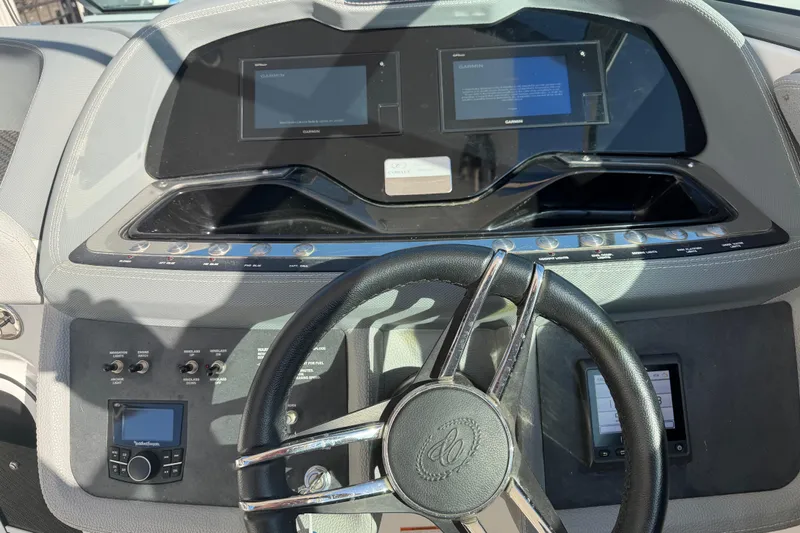  Yacht Photos Pics Dashboard of a 2019 Cobalt R35 boat with steering wheel and control panels.