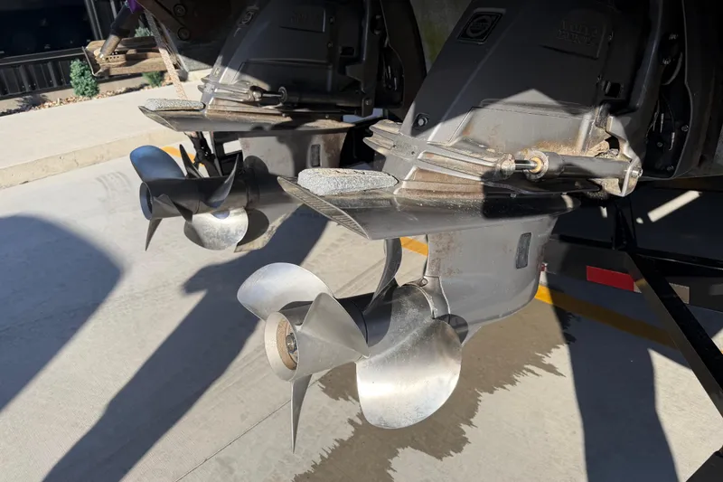  Yacht Photos Pics Dual propellers on a 2019 Cobalt R35 boat, parked on concrete.