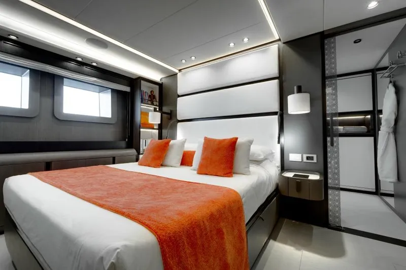 L.a.u.l Yacht Photos Pics Luxurious bedroom interior on 2019 ISA Extra 130 yacht with modern design and orange accents.