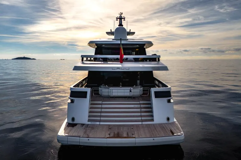 L.a.u.l Yacht Photos Pics Luxury yacht ISA Extra 130, 2019 model, cruising on calm ocean waters at sunset.