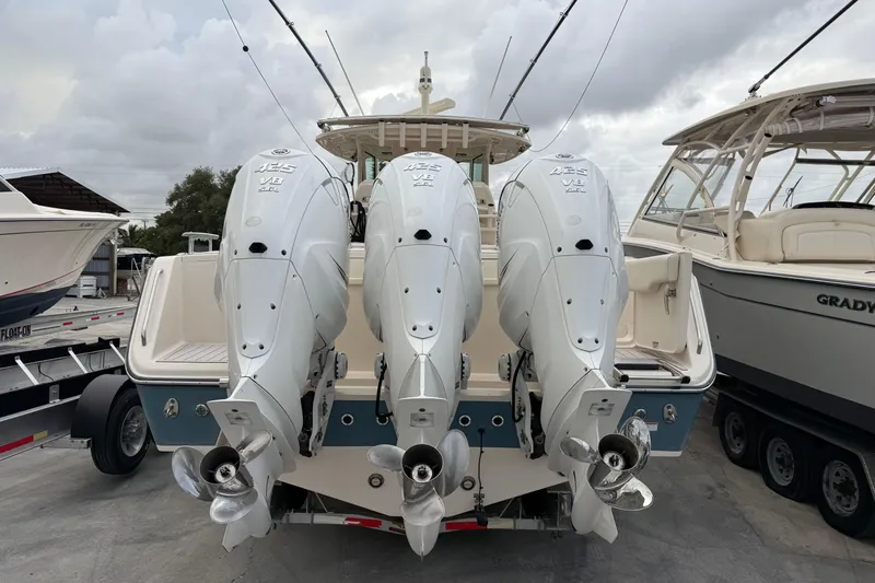 376-420 Brokerage Tyler Yacht Photos Pics 2020 Grady-White Canyon 376 boat with triple outboard engines, docked at a marina.