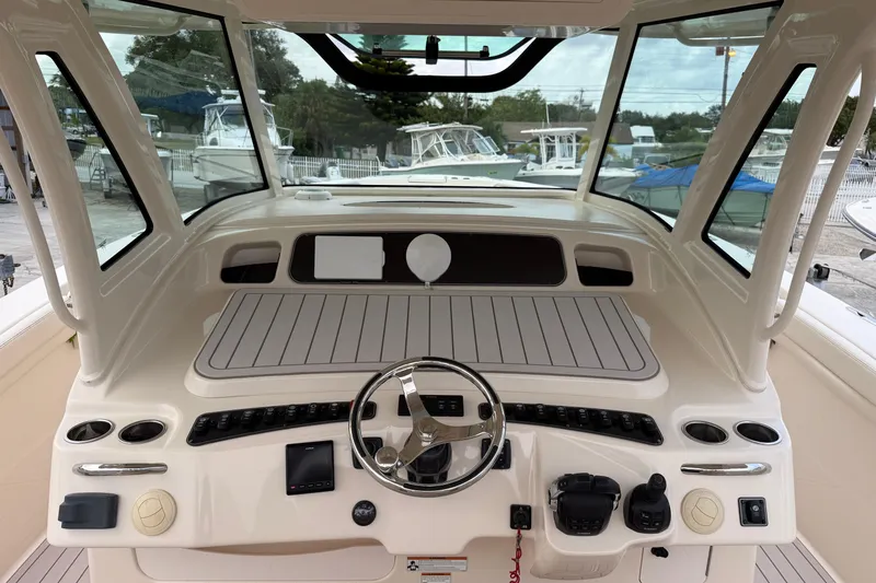 376-420 Brokerage Tyler Yacht Photos Pics 2020 Grady-White Canyon 376 helm with steering wheel and control panel.