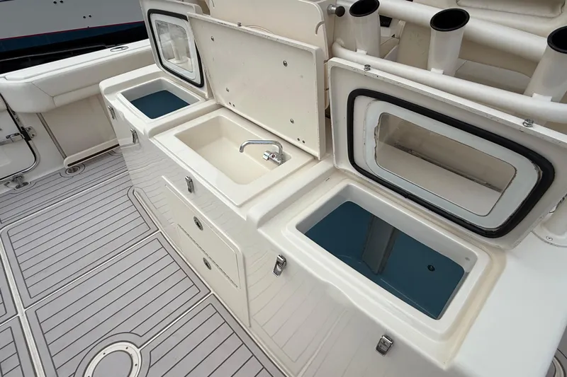 376-420 Brokerage Tyler Yacht Photos Pics 2020 Grady-White Canyon 376 boat interior with sink and storage compartments.