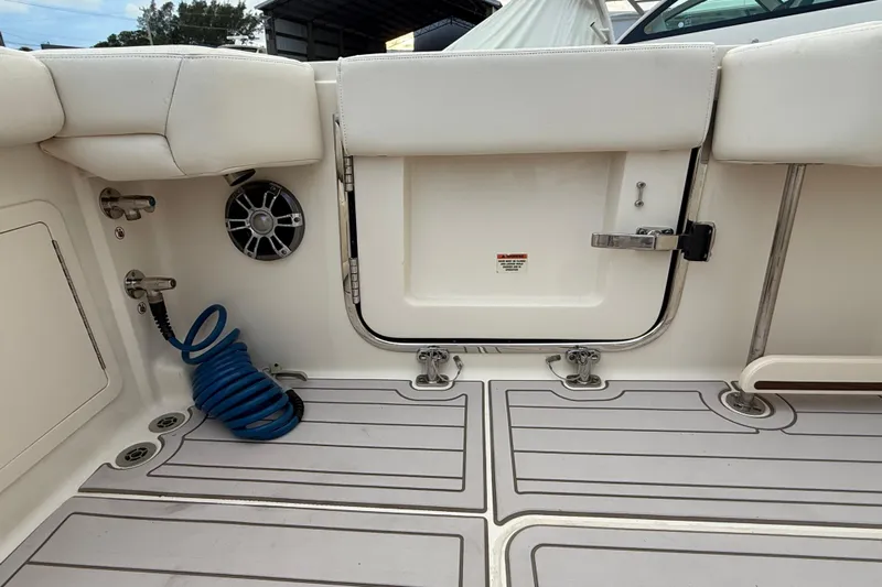 376-420 Brokerage Tyler Yacht Photos Pics 2020 Grady-White Canyon 376 boat interior with coiled blue hose and speaker.
