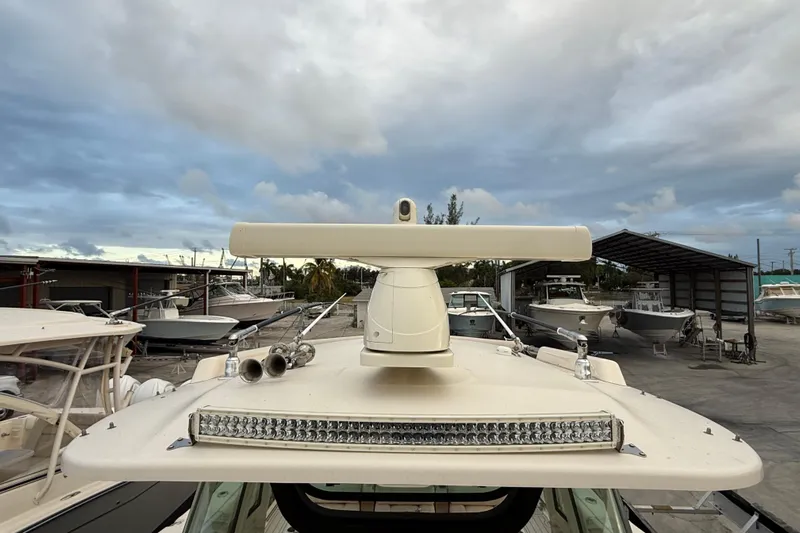 376-420 Brokerage Tyler Yacht Photos Pics 2020 Grady-White Canyon 376 boat with radar and light bar, docked under cloudy skies.