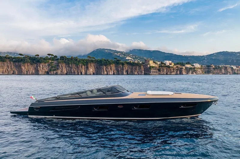  Yacht Photos Pics 2023 Itama 62 RS yacht cruising near scenic coastal cliffs.
