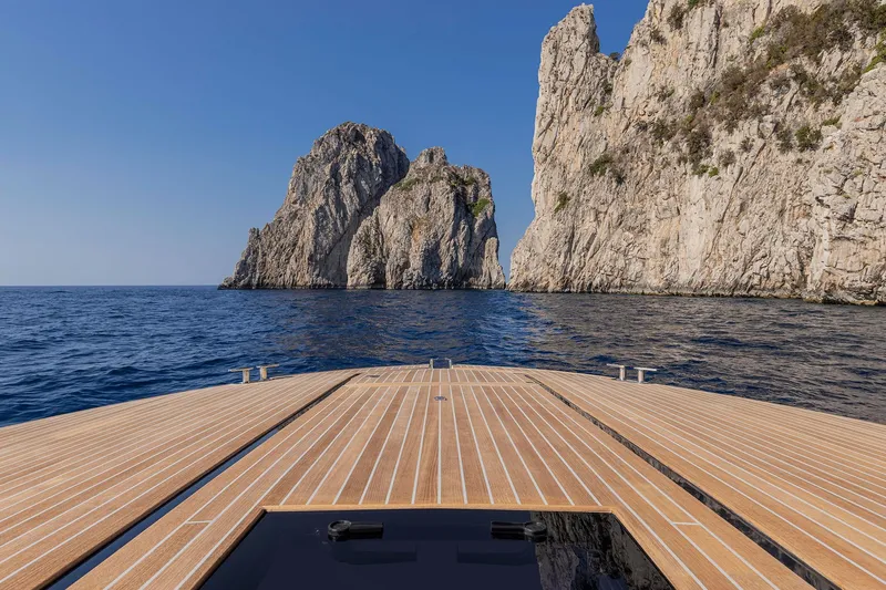  Yacht Photos Pics Itama 62 RS yacht cruising near rocky cliffs, 2023 model.