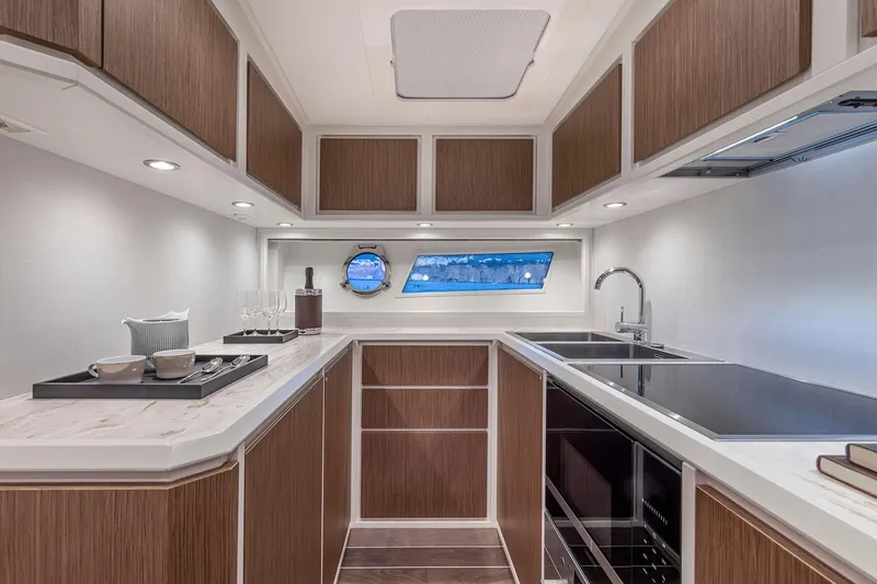  Yacht Photos Pics Luxurious kitchen interior of 2023 Itama 62 RS yacht with modern design and amenities.