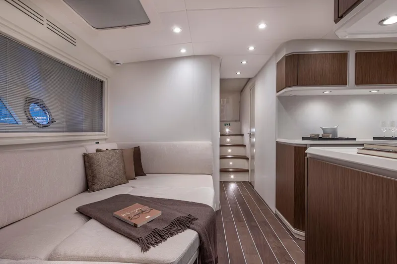  Yacht Photos Pics Luxurious interior of 2023 Itama 62 RS yacht with modern furnishings and elegant lighting.