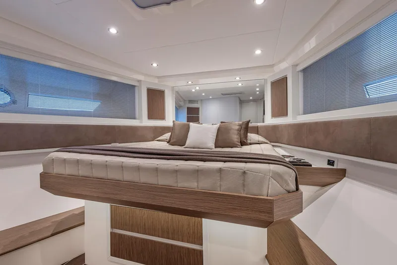  Yacht Photos Pics Luxurious interior of 2023 Itama 62 RS yacht with elegant bedding and modern design.
