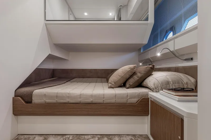  Yacht Photos Pics Luxurious interior cabin of 2023 Itama 62 RS yacht with cozy bed and modern design.