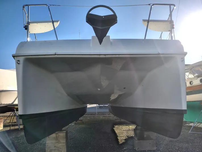Journey Yacht Photos Pics 2002 Endeavour Trawlercat 36 catamaran, rear view, elevated on blocks, sunny day.
